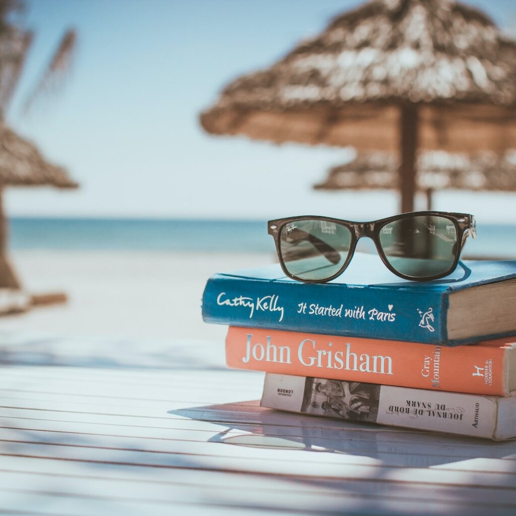 black framed Ray-Ban Wayfarer sunglasses on top of book